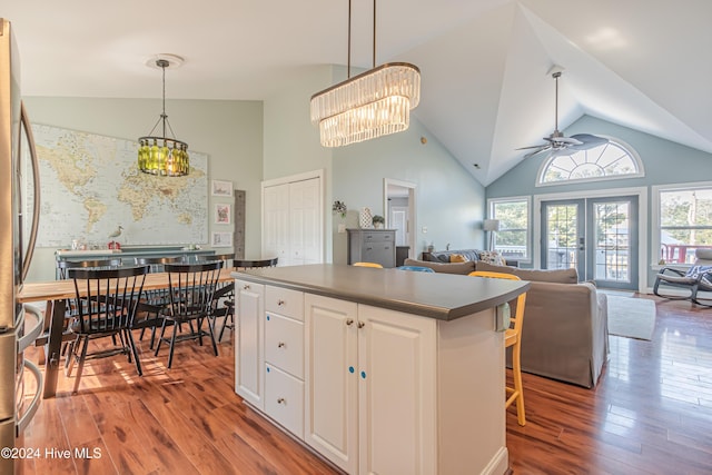 kitchen featuring white cabinets, hardwood / wood-style floors, ceiling fan, and pendant lighting