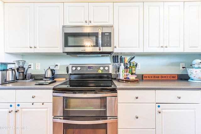 kitchen featuring white cabinets and appliances with stainless steel finishes