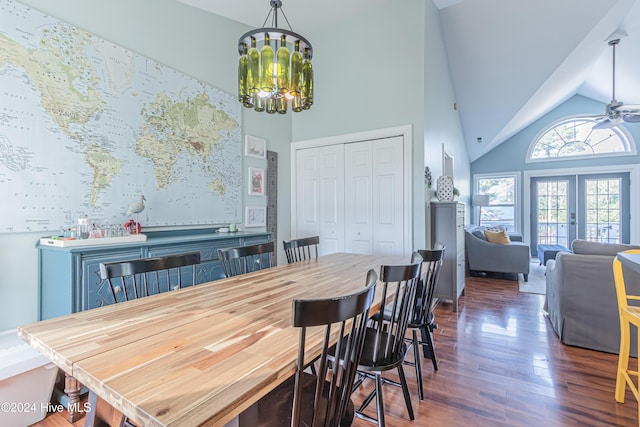 dining space featuring ceiling fan with notable chandelier, french doors, high vaulted ceiling, and dark hardwood / wood-style floors