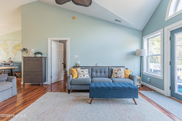 living room featuring high vaulted ceiling, ceiling fan, and dark wood-type flooring