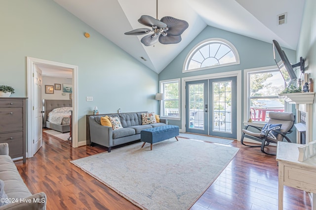 living room featuring plenty of natural light, dark wood-type flooring, and high vaulted ceiling