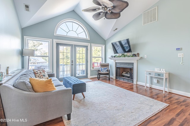 living room with ceiling fan, french doors, high vaulted ceiling, and wood-type flooring