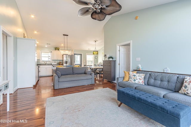 living room featuring ceiling fan, dark hardwood / wood-style flooring, and lofted ceiling