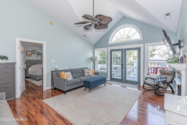 living room with french doors, dark hardwood / wood-style floors, high vaulted ceiling, and ceiling fan