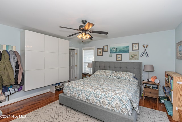 bedroom with light hardwood / wood-style flooring and ceiling fan