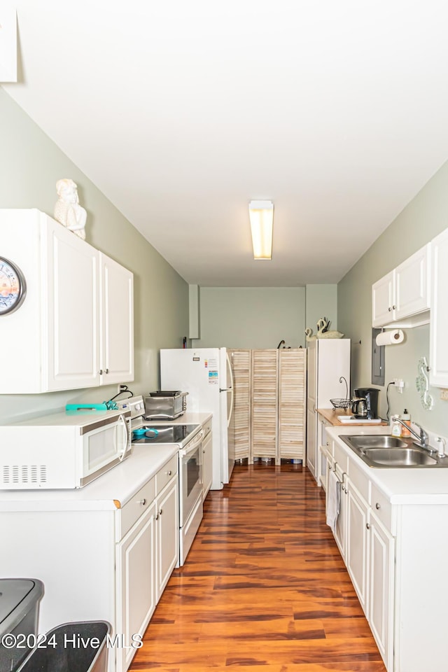 kitchen featuring white cabinets, white appliances, light hardwood / wood-style flooring, and sink