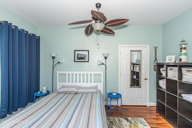 bedroom with ceiling fan and dark hardwood / wood-style flooring