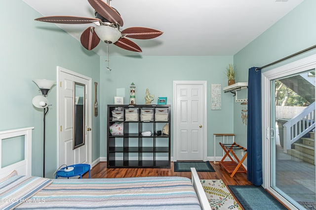 bedroom featuring dark hardwood / wood-style flooring, ceiling fan, and access to exterior