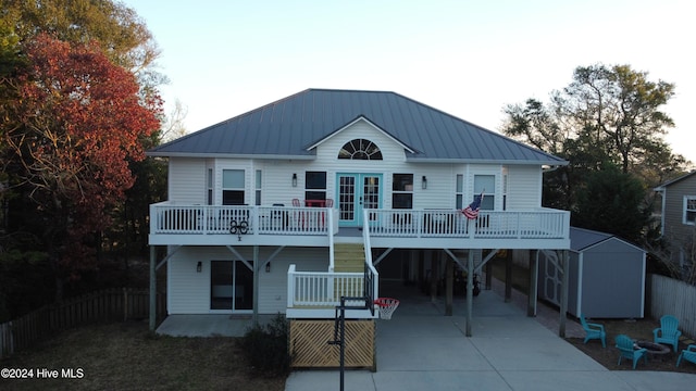 view of front of house featuring a carport and a storage shed