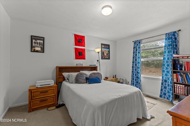 bedroom featuring light carpet