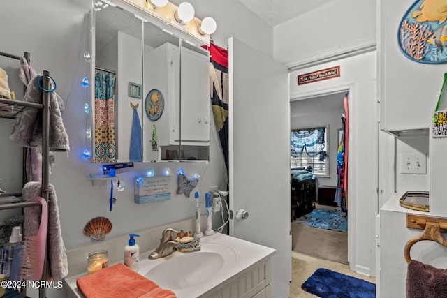 bathroom with vanity, a textured ceiling, and walk in shower