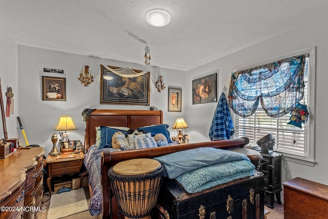 bedroom featuring carpet and a textured ceiling