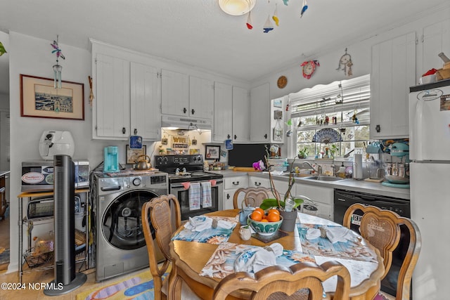 kitchen featuring washer / dryer, sink, white cabinetry, and black appliances