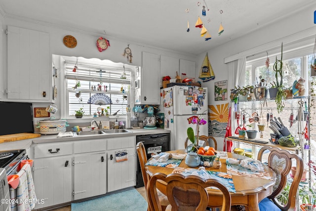 kitchen with white cabinets, stainless steel range, white fridge, and sink