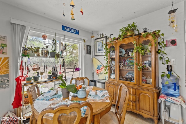 dining space with a textured ceiling