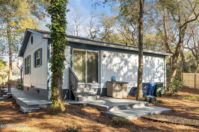 rear view of house with a wooden deck