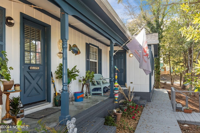 151 Hoop Pole Creek Dr Unit E & W, Atlantic Beach, NC 28512 - property entrance featuring covered porch and board and batten siding