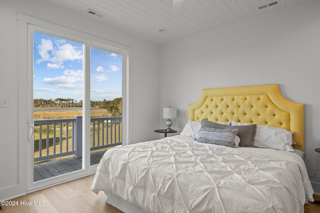 bedroom featuring light hardwood / wood-style floors and access to exterior