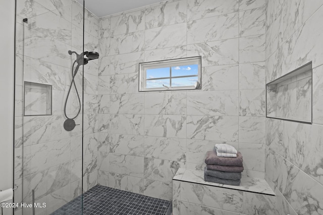 bathroom with a tile shower