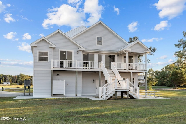 rear view of property with a lawn