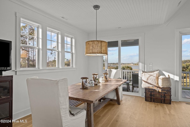 dining area featuring light hardwood / wood-style flooring and ornamental molding