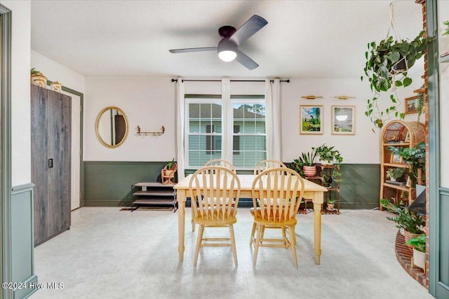 dining area with ceiling fan, light colored carpet, and a textured ceiling