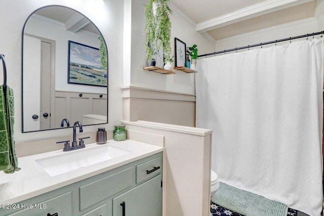 bathroom with crown molding, vanity, and toilet