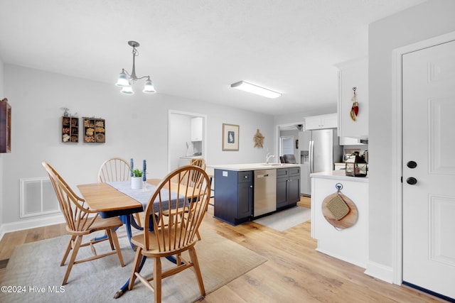 dining space featuring a chandelier and light hardwood / wood-style flooring