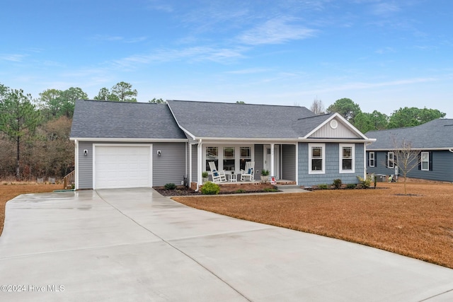 ranch-style house featuring a porch and a garage