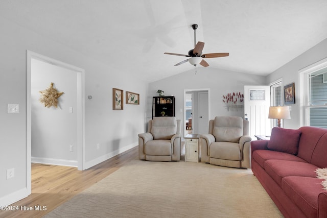 living room featuring light wood-type flooring, plenty of natural light, lofted ceiling, and ceiling fan