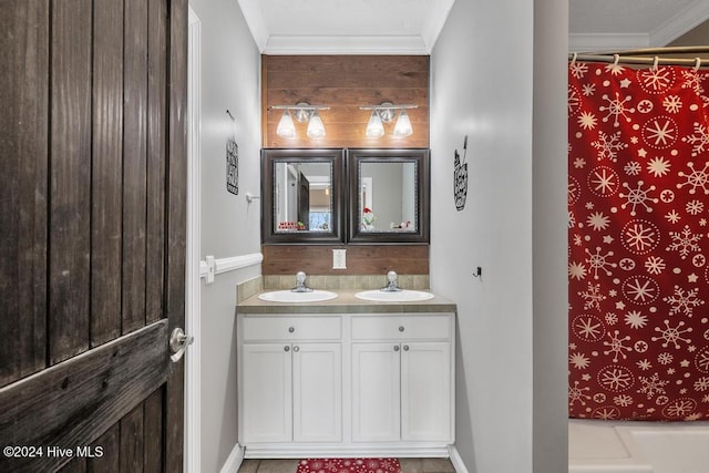 bathroom featuring walk in shower, vanity, and ornamental molding