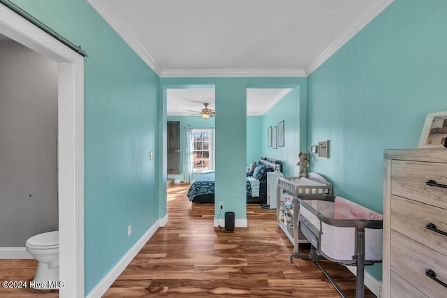 interior space featuring ceiling fan, dark hardwood / wood-style flooring, and crown molding