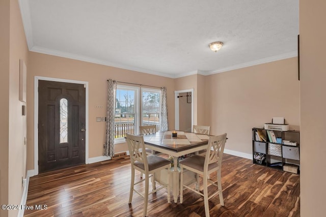 dining room featuring dark hardwood / wood-style floors and crown molding