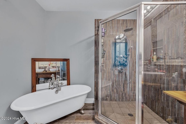 bathroom with hardwood / wood-style floors and separate shower and tub