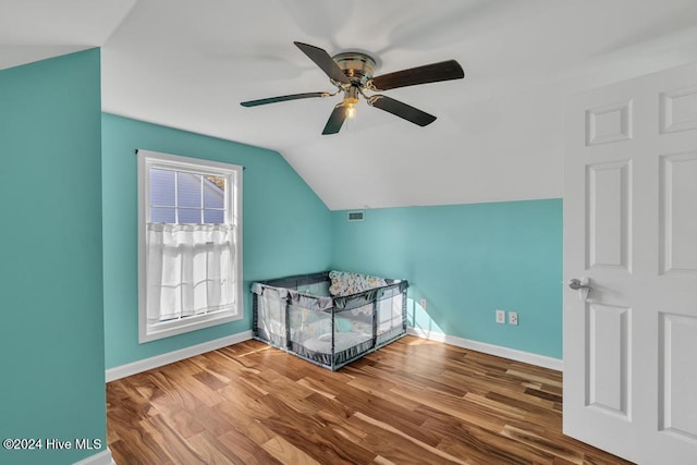 additional living space with ceiling fan, hardwood / wood-style floors, and lofted ceiling