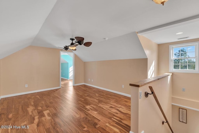 additional living space featuring ceiling fan, wood-type flooring, and vaulted ceiling