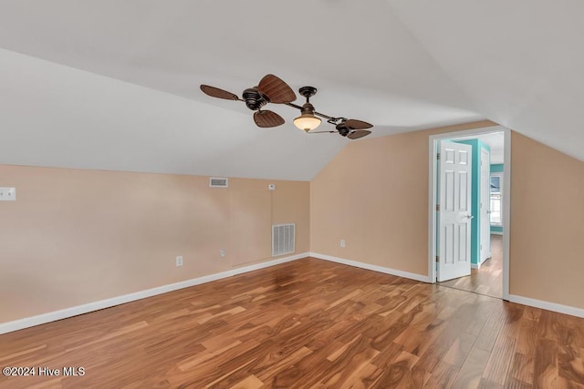 additional living space with hardwood / wood-style flooring, ceiling fan, and vaulted ceiling