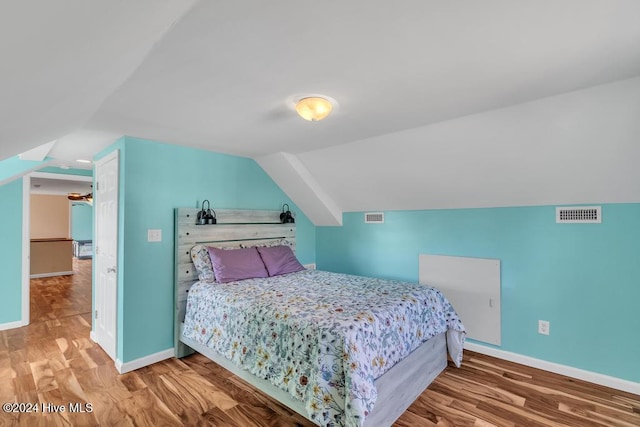 bedroom featuring lofted ceiling and wood-type flooring