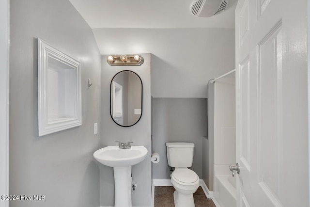 full bathroom with sink, tile patterned flooring, lofted ceiling, toilet, and shower / washtub combination