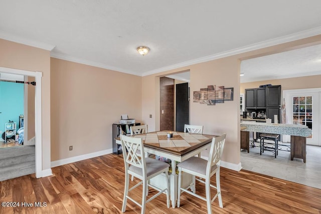 dining room featuring wood-type flooring and ornamental molding