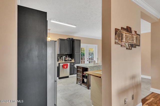 kitchen featuring french doors, hanging light fixtures, ornamental molding, a textured ceiling, and appliances with stainless steel finishes