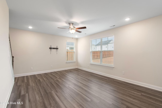 empty room featuring ceiling fan and dark wood-type flooring