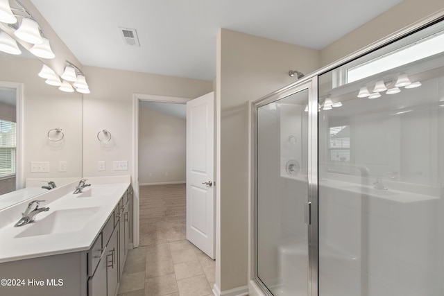 bathroom featuring tile patterned flooring, vanity, and an enclosed shower