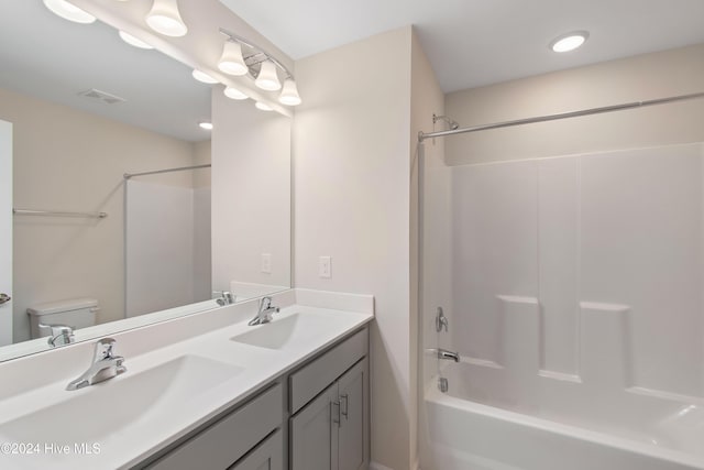 full bathroom with vanity, toilet, and washtub / shower combination