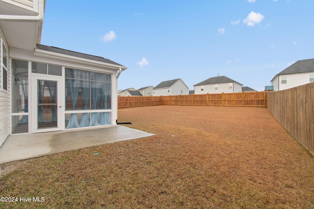 view of yard featuring a patio area and a sunroom