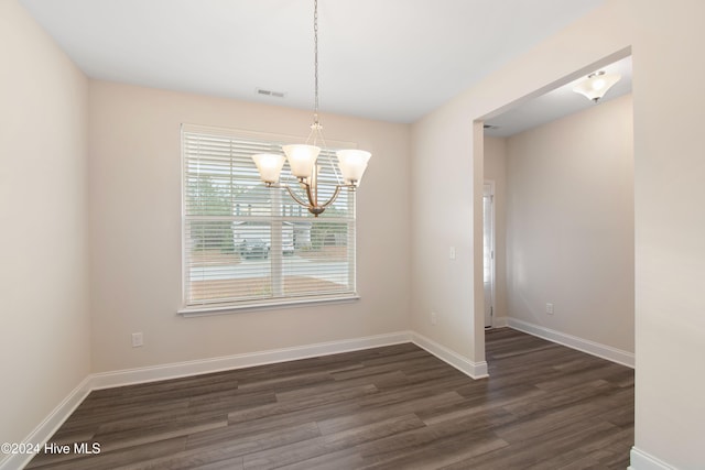 unfurnished dining area with an inviting chandelier and dark wood-type flooring