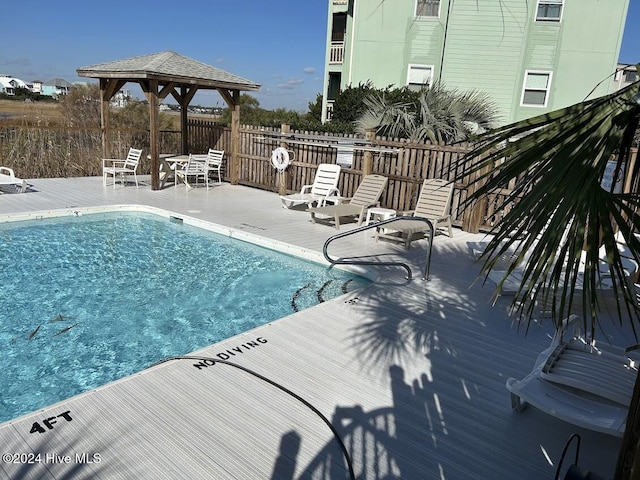 view of swimming pool featuring a gazebo and a patio area