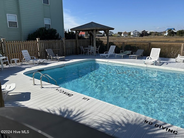 view of swimming pool with a gazebo and a patio