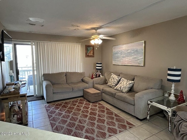 tiled living room with ceiling fan and a textured ceiling