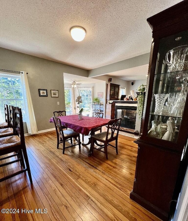 dining area featuring light hardwood / wood-style floors and a textured ceiling